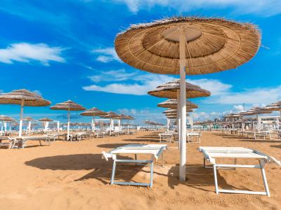 Rimini empty beach with chaise lounges and umbrellas.
