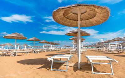 Rimini empty beach with chaise lounges and umbrellas.