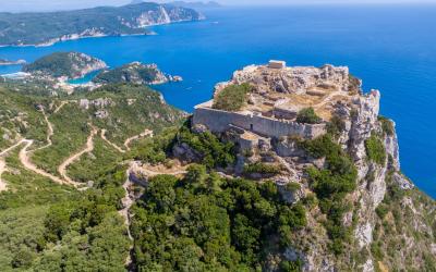 Aerial drone view of famous iconic medieval fortified castle of Aggelokastro with amazing views to Paleokastritsa bay, Corfu Greece