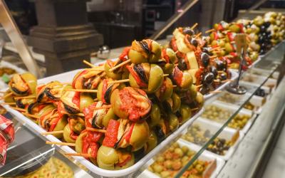 Stuffed green olives on wooden sticks on sale at Mercado San Miguel market in Madrid, Spain