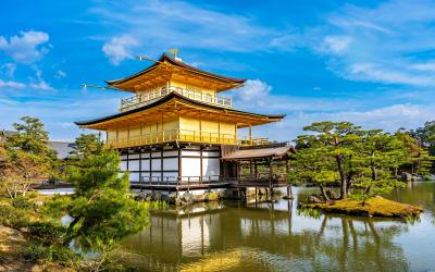 Kinkakuji Temple by the middle of the pond surrounded with Japanese garden