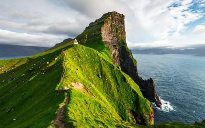 Kallur lighthouse on green hills of Kalsoy island, Faroe island