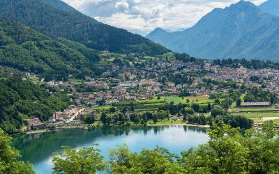 Aerial view of the small town of Levico Terme with the lake (Lago di Levico) and the mountains, Alps. Trentino Alto Adige, Italy, Europe