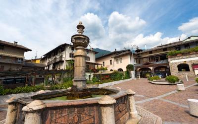 Detail of an ancient marble octagonal fountain (1553) in Levico Terme (Venezia Square), Trentino Alto Adige, Italy, Europe