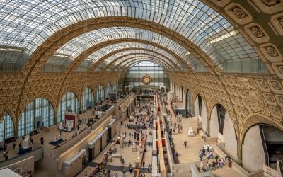 Orsay museum. View of the main hall of the museum without visitors, the golden clock and the glass canopy background, paris