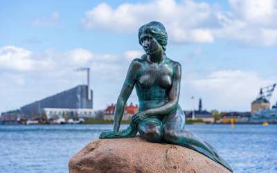 Bronze statue of the Little Mermaid sitting on a rock at Langelinie Pier by Edvard Eriksen